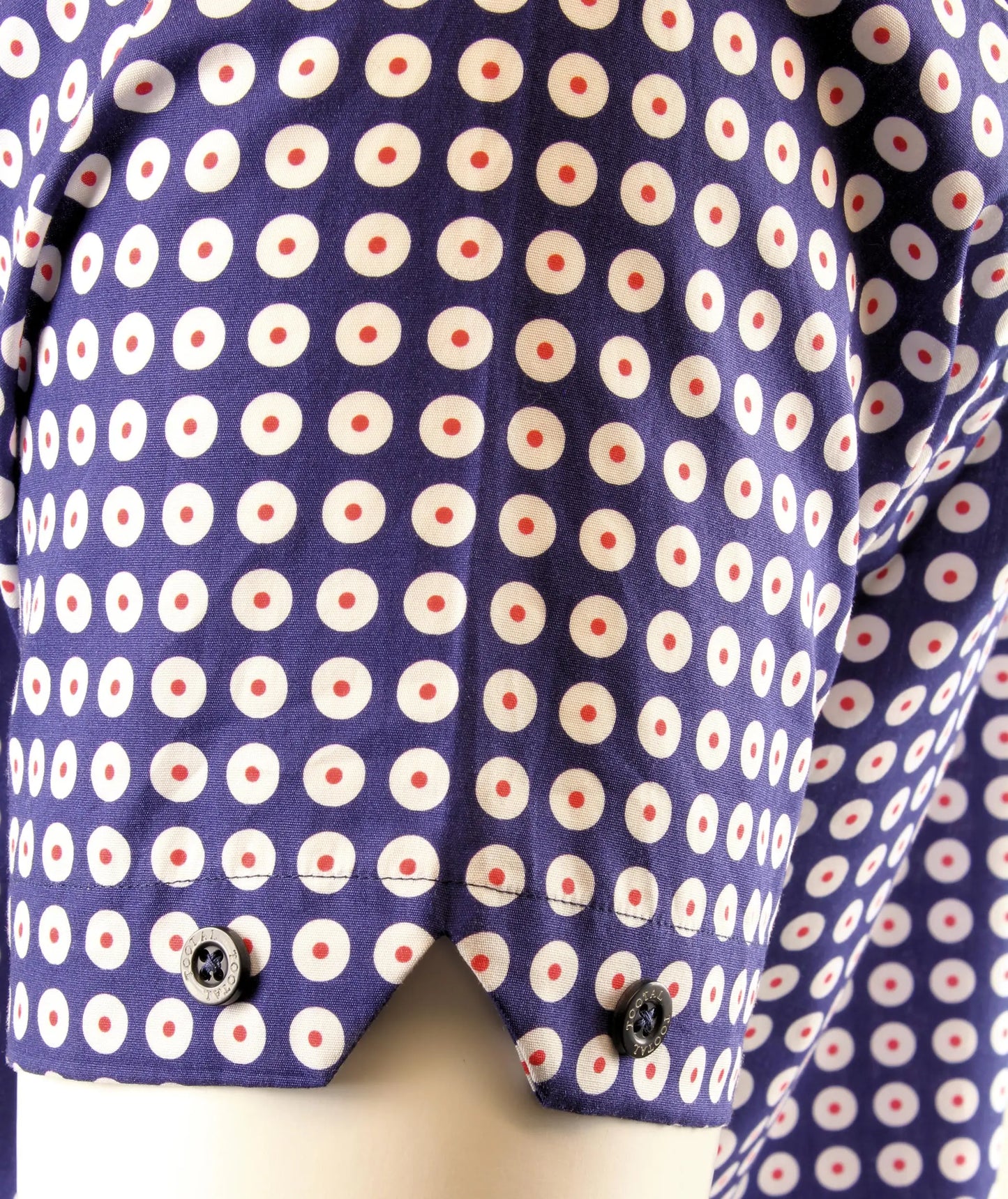Close-up of a shirt with a target pattern on a mannequin.