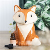 Fox-shaped container with a small bottle on a wooden surface
