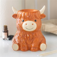 Ceramic cow-shaped container on a surface with a blurred background