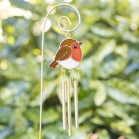 Decorative wind chime with a robin design against a blurred green background